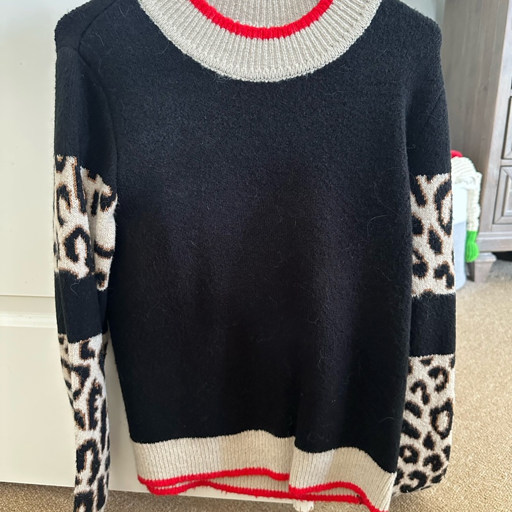 THML Black Crewneck Sweater with Beige Leopard Sleeves and Red Trim Accents